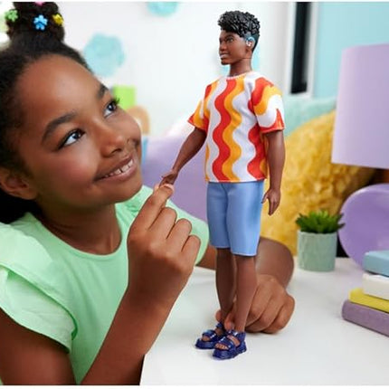 Barbie Fashionistas Ken Doll #220 with Behind-The-Ear Hearing Aids & Broad Body Wearing a Removable Orange Patterned Shirt, Shorts & Jelly Sandals